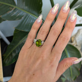 14K white gold peridot oval ring with diamond halo