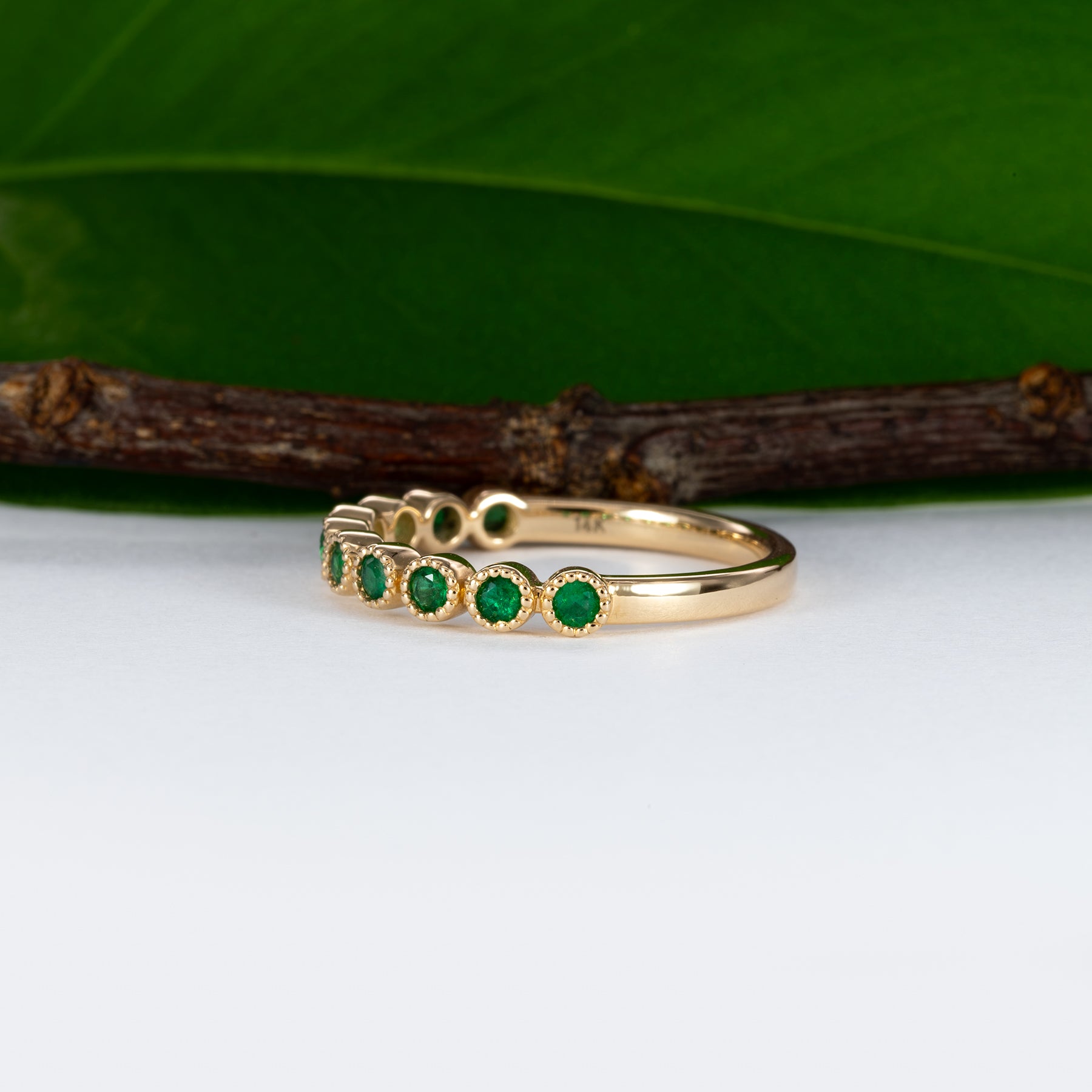 14K yellow gold band with round Zambian emerald accents