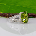 14K white gold peridot oval ring with diamond halo