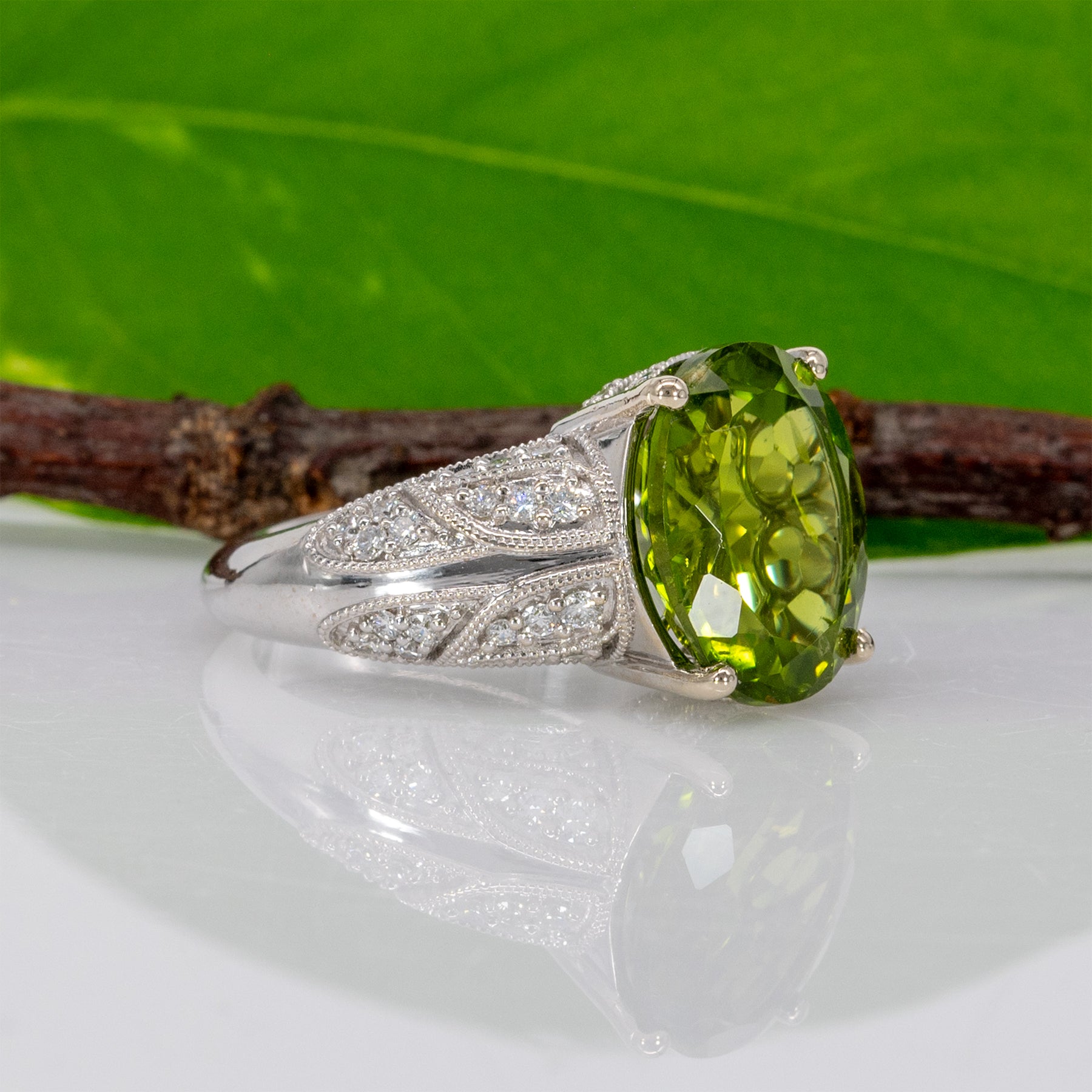 14K white gold peridot oval ring with diamond halo