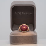 14K rose gold star ruby cabochon ring with diamond halo