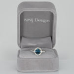 14K white gold teal sapphire oval ring with diamond halo