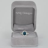 14K white gold teal sapphire oval ring with diamond halo