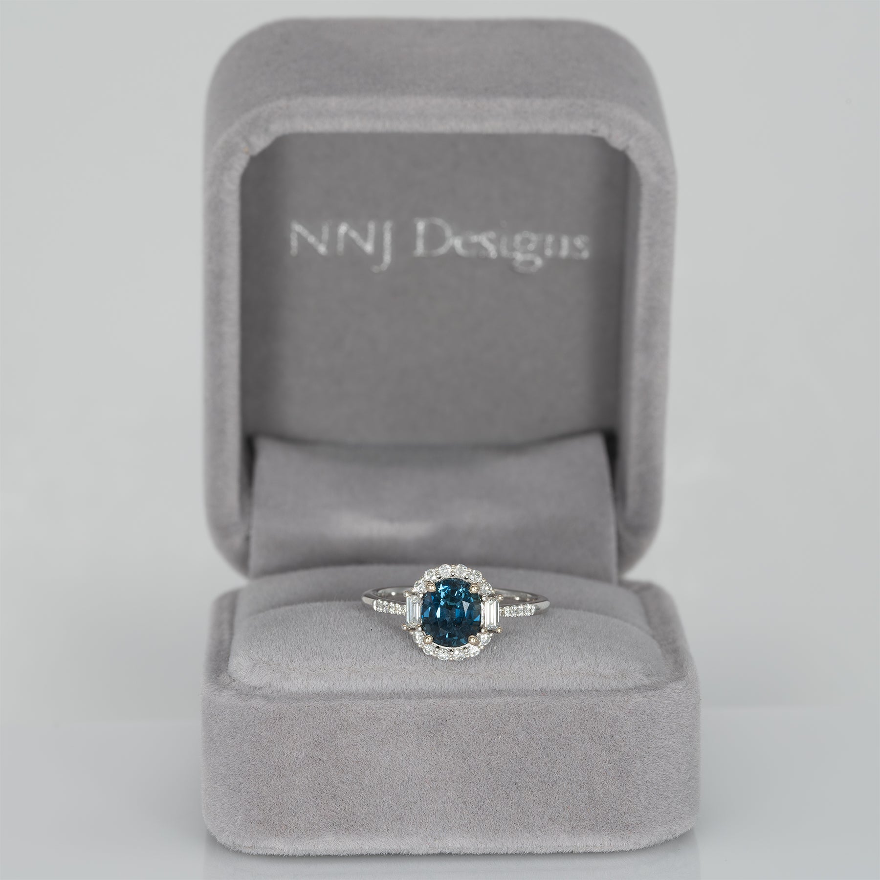14K white gold teal sapphire oval ring with diamond halo