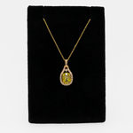 Sphene oval pendant with diamond accents in 14k yellow gold
