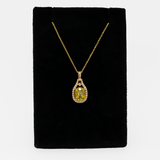 Sphene oval pendant with diamond accents in 14k yellow gold
