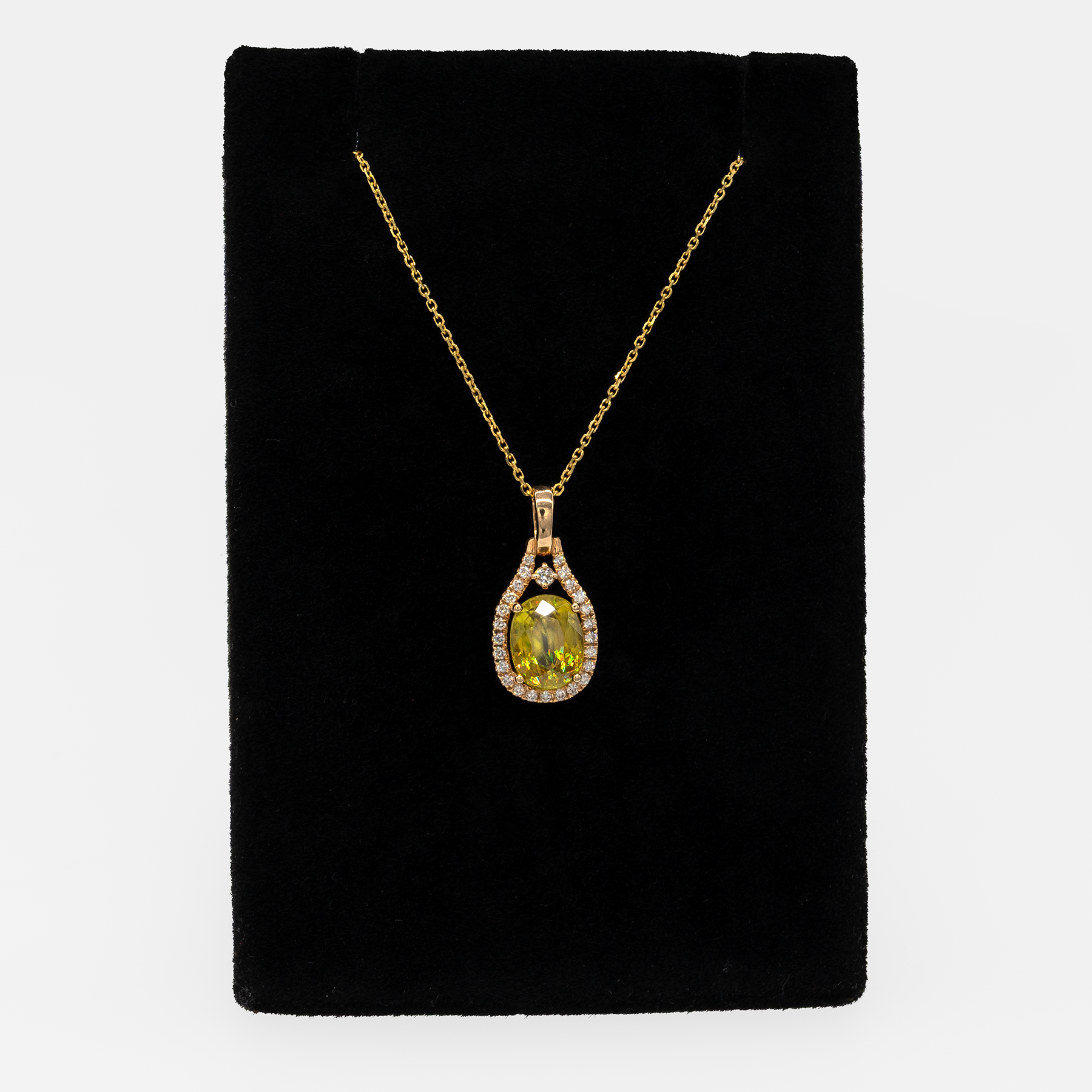 Sphene oval pendant with diamond accents in 14k yellow gold