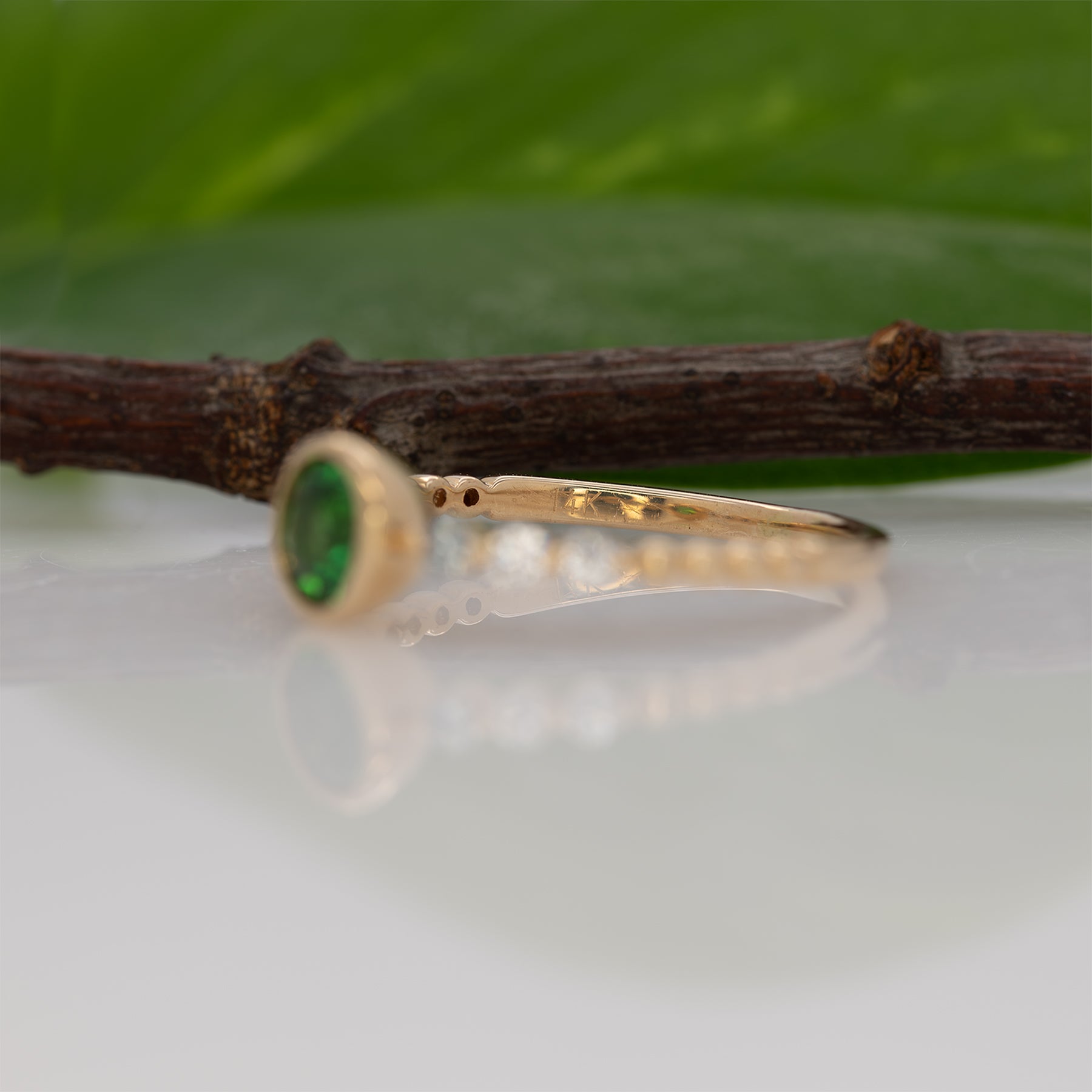 14K yellow gold tsavorite garnet round ring with diamond accents