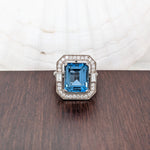 Glamorous London Blue Topaz Ring with All Natural Diamond Pave Halo in Solid 14K White Gold | Emerald Cut 12x10mm | December Birthstone