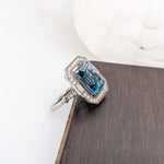 Glamorous London Blue Topaz Ring with All Natural Diamond Pave Halo in Solid 14K White Gold | Emerald Cut 12x10mm | December Birthstone